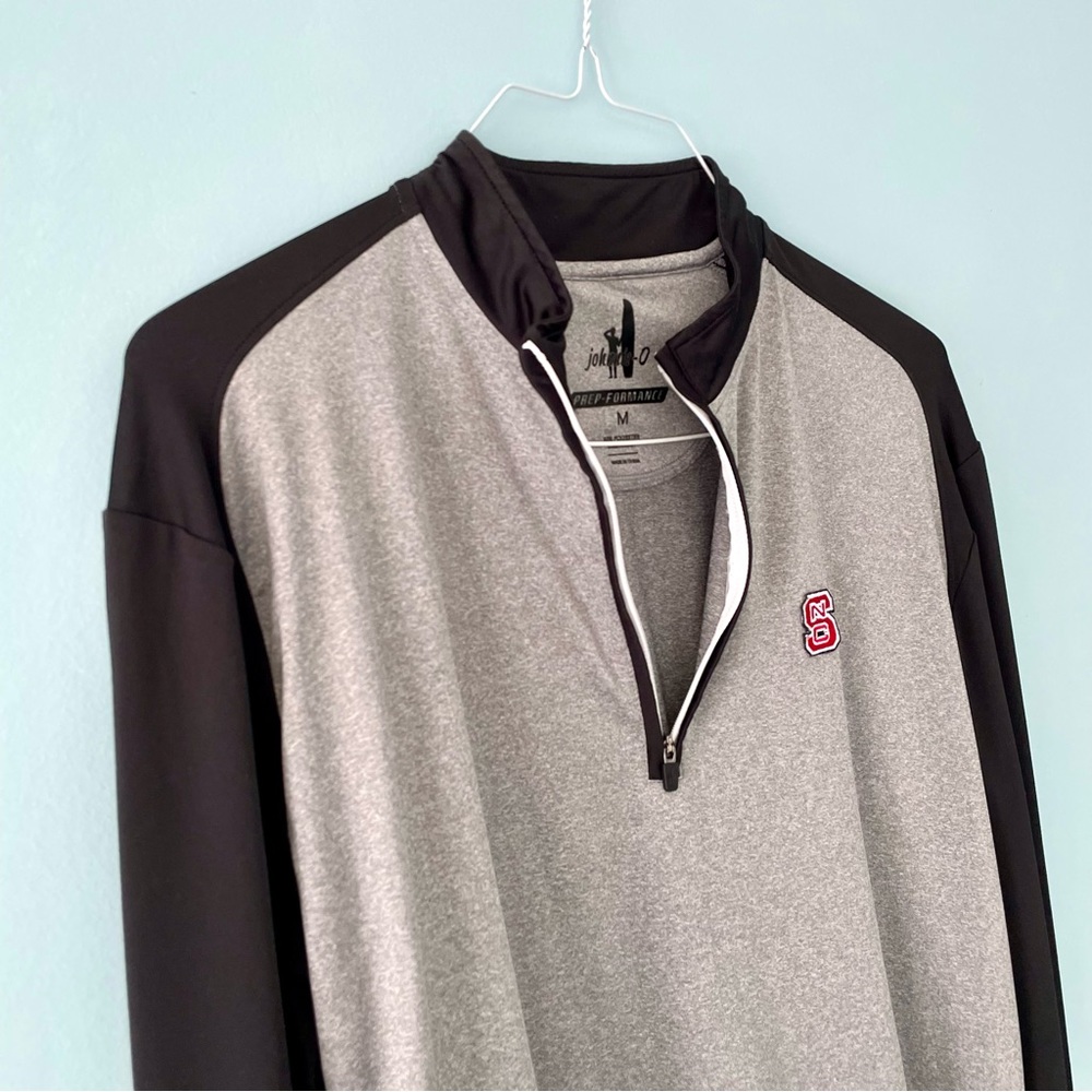 JOHNNIE-O Men’s Sway Classic Fit Raglan 1/4 Zip Pullover in Black.  NC State